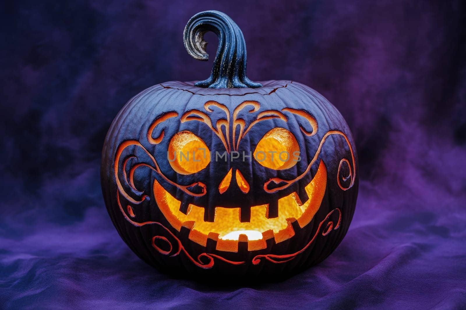 A beautifully carved pumpkin features an intricate design, illuminated from within, casting a warm glow in the dark setting.