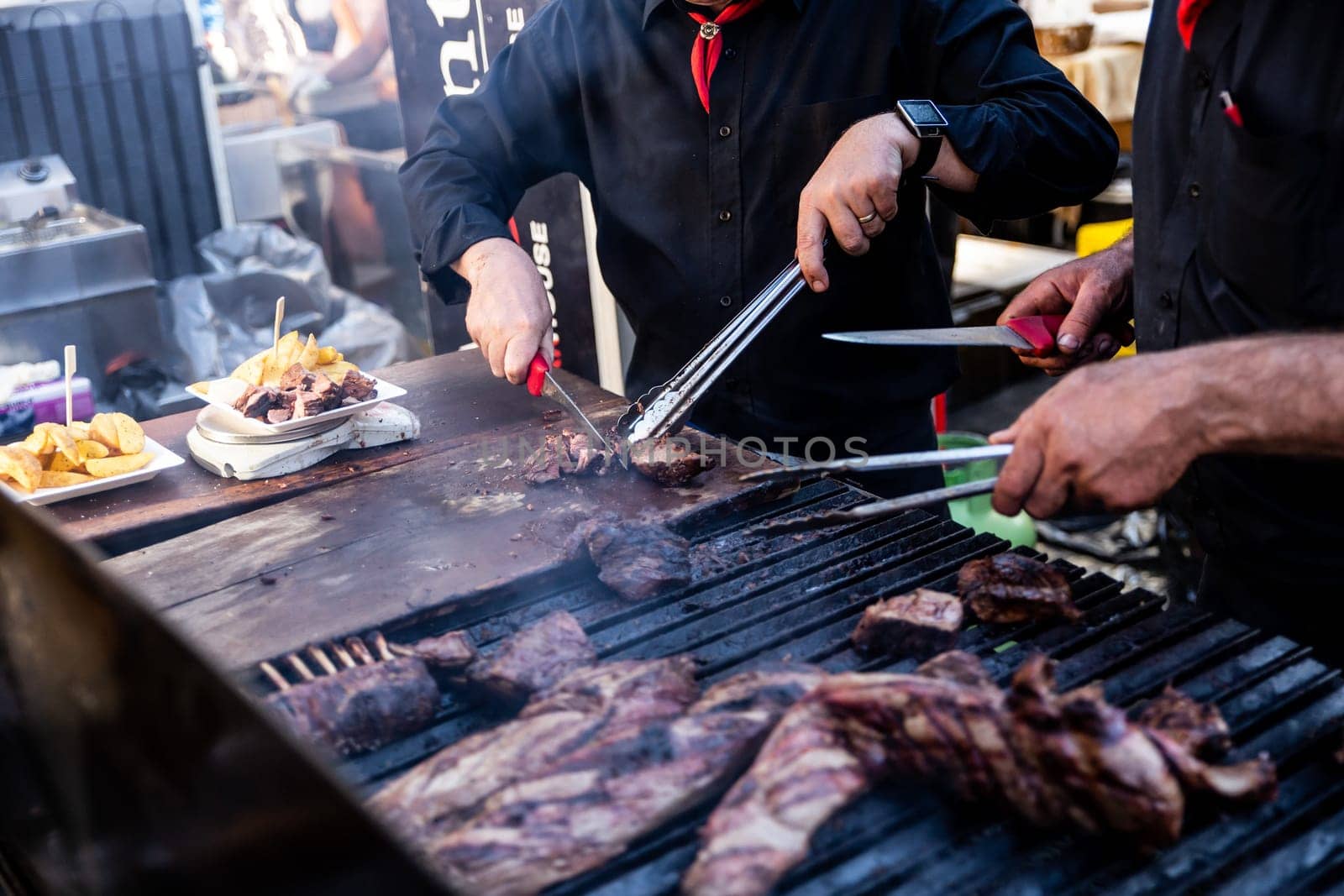 Some excellent pieces of Argentinian beef on a charcoal grill being prepared at open kitchen street food festival in Ljubljana, Slovenia
