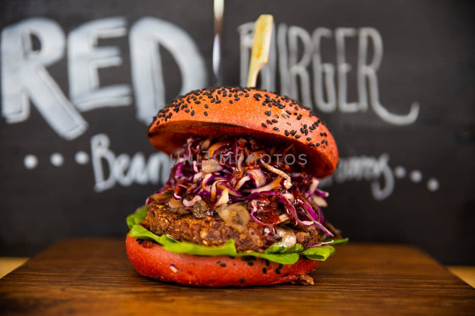 Fresh colorful vegan burgers with vegetables on counter at summer local food market - close up view. Outdoor cooking, gastronomy, vegetarian, street food concept
