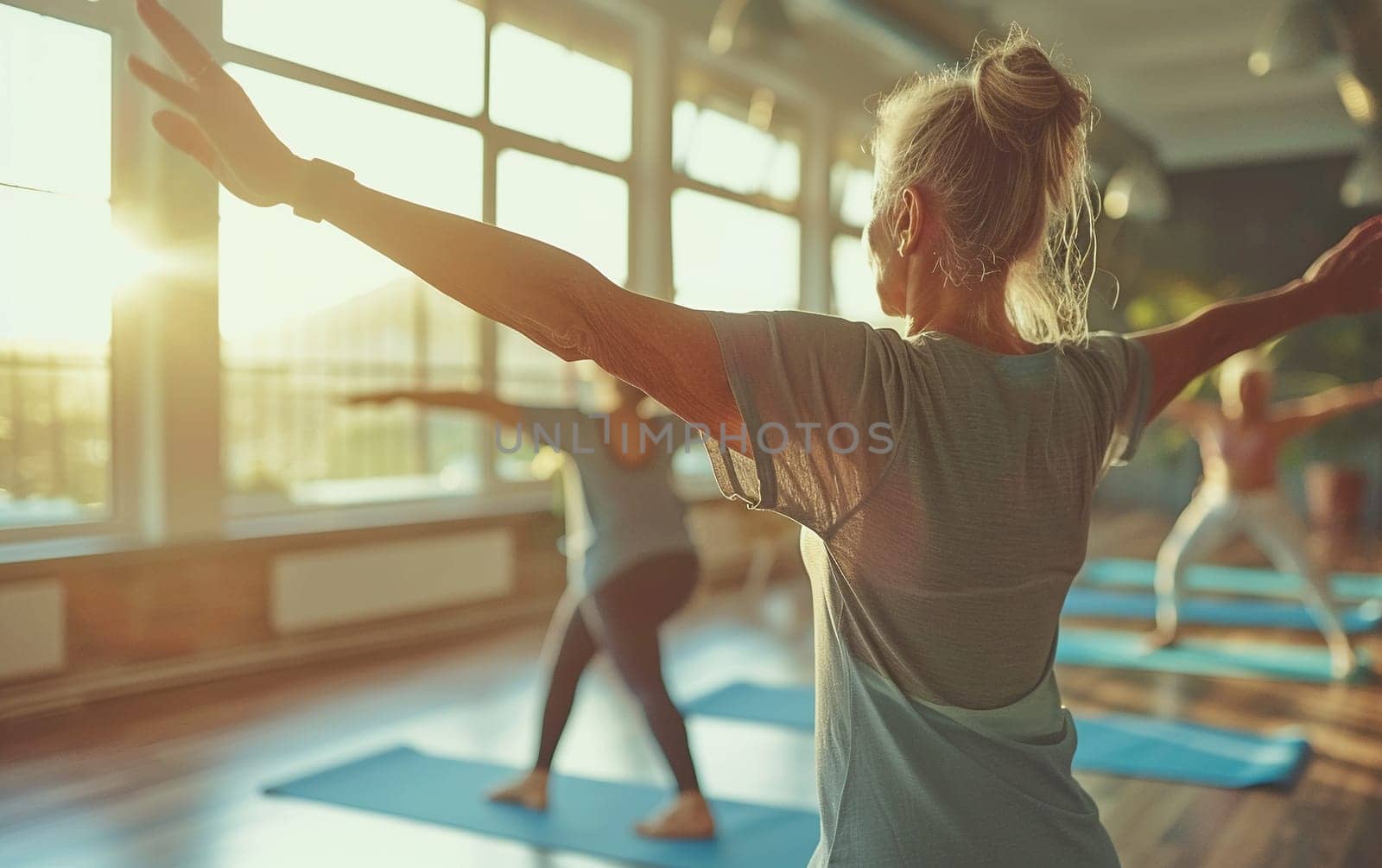 Senior woman doing yoga in sunny studio, focusing on her balance and flexibility, healthy aging and wellness concept