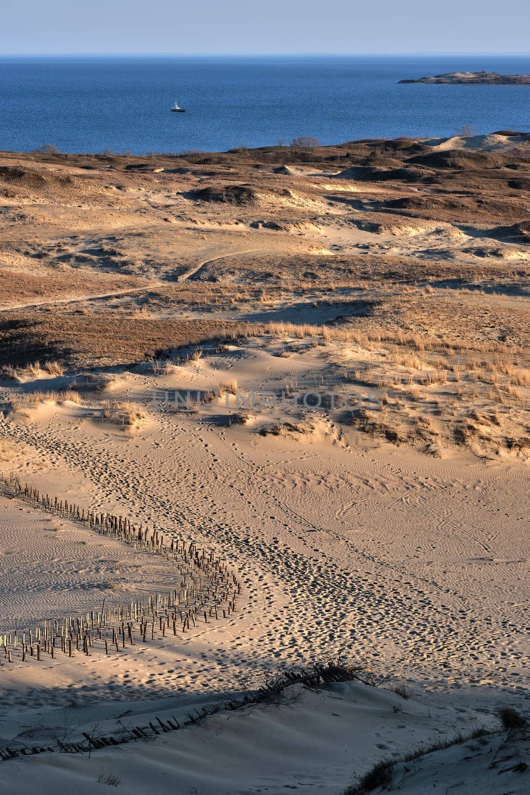 Early spring nature of nordic dunes, Baltic sea and Curonian spit, Nida, Klaipeda, Lithuania at sunset. Lines, rhythm and patterns of shadows and hills