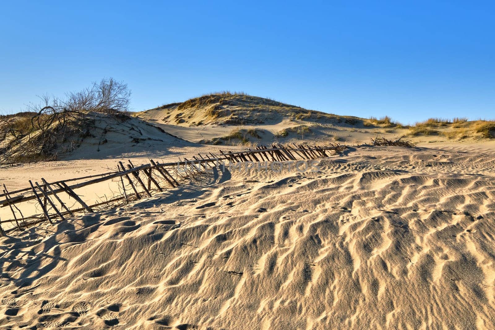 Nordic sand dunes, Baltic sea, Curonian spit, Nida, Klaipeda, Lithuania at sunset. Lines, rhythm and patterns of shadows
