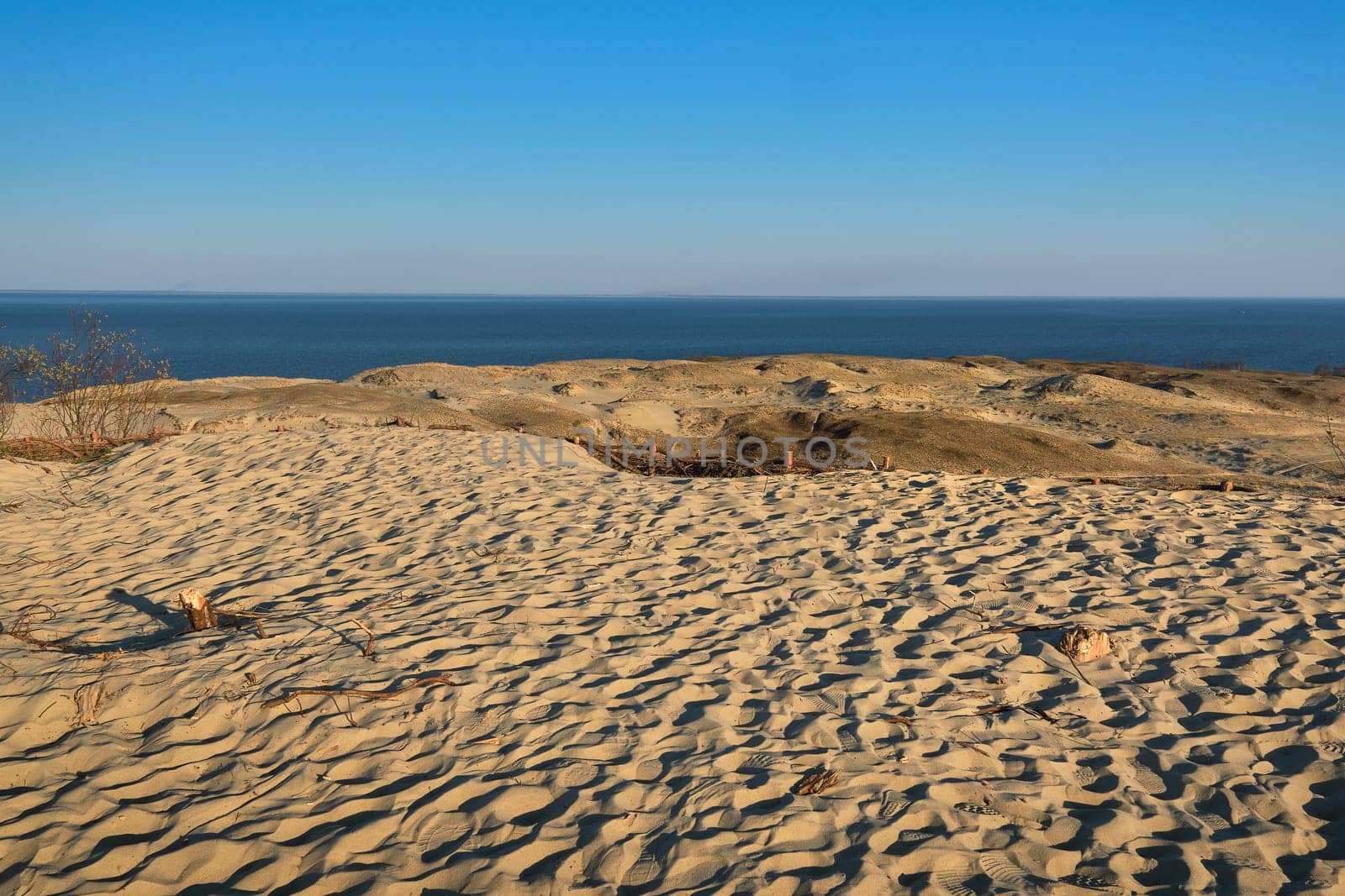 Nordic sand dunes, Baltic sea, Curonian spit, Nida, Klaipeda, Lithuania at sunset. Lines, rhythm and patterns of shadows and hills