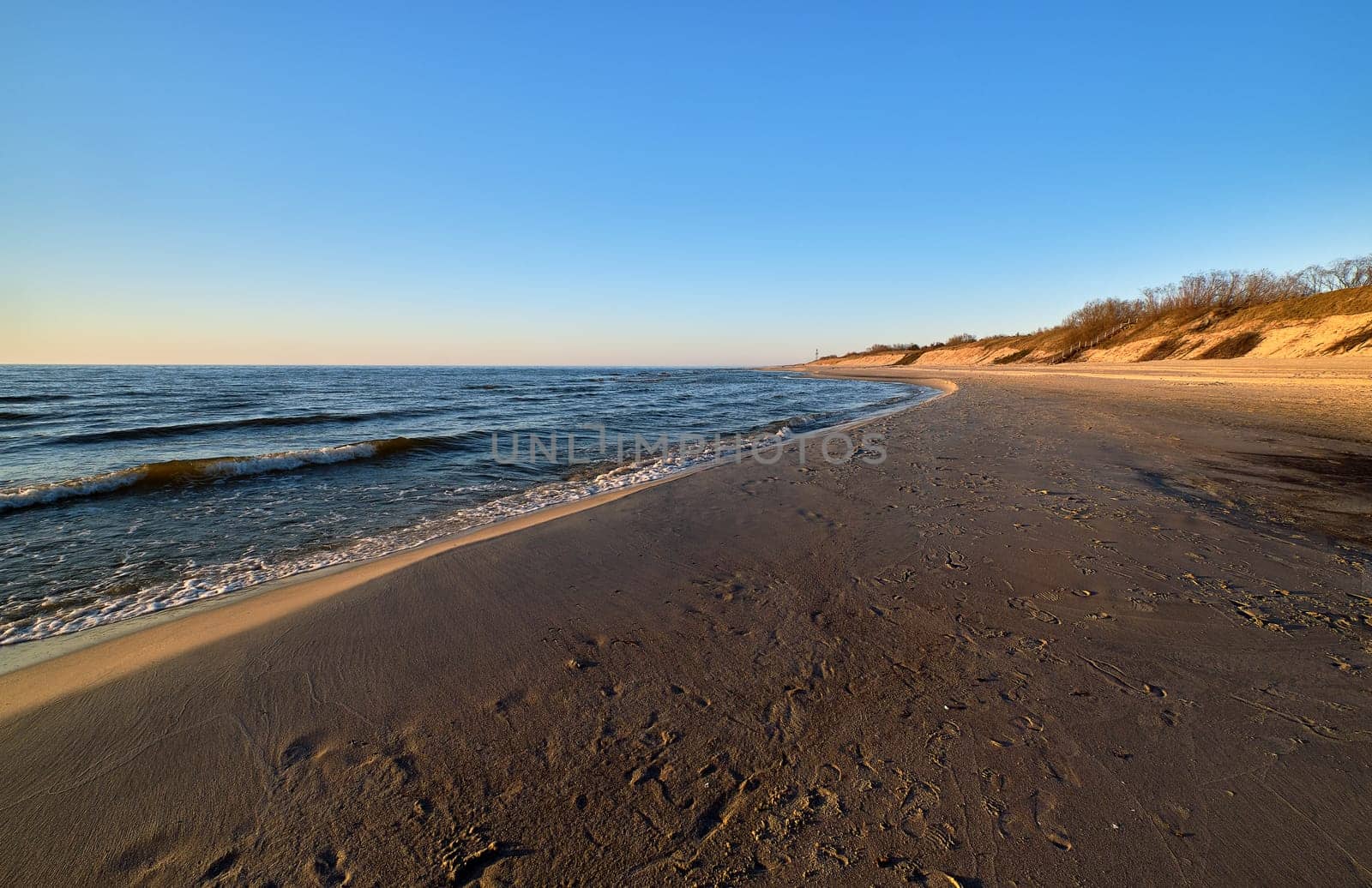 Beautiful, ethereal, calm sunset at Baltic sea and nordic sand dunes of Curonian spit, Nida, Lithuania