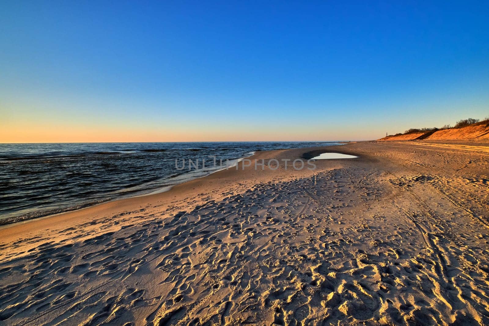 Beautiful, ethereal, calm sunset at Baltic sea and nordic sand dunes of Curonian spit, Nida, Lithuania