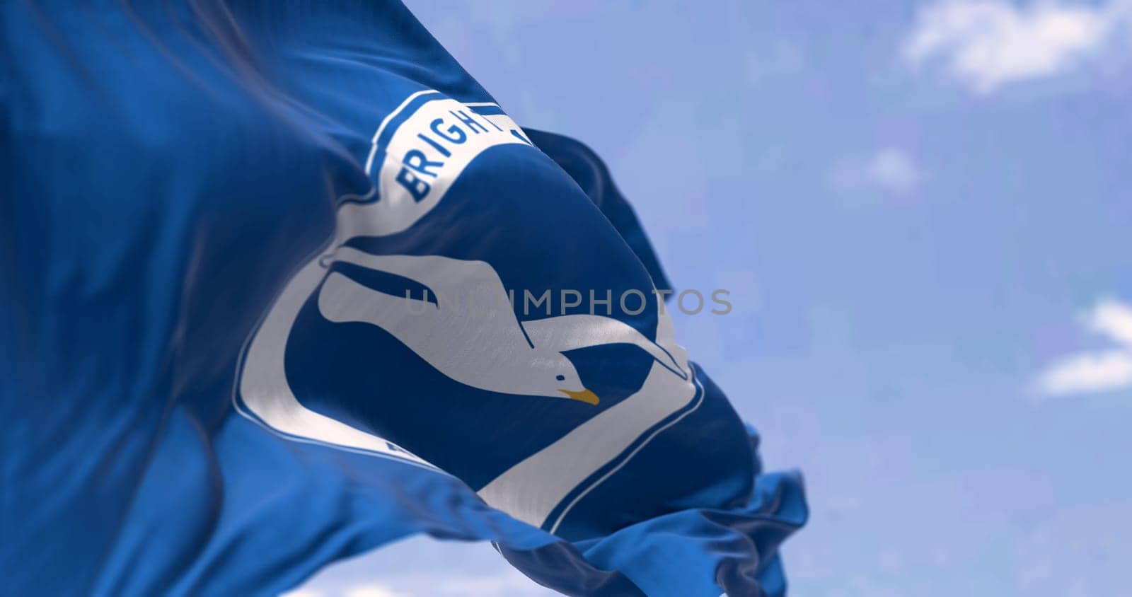 Brighton, UK, May 2023: Brighton and Hove Albion Football Club flag waving in the wind on a clear day. English Premier League team. Illustrative editorial 3d illustration render. Selective focus