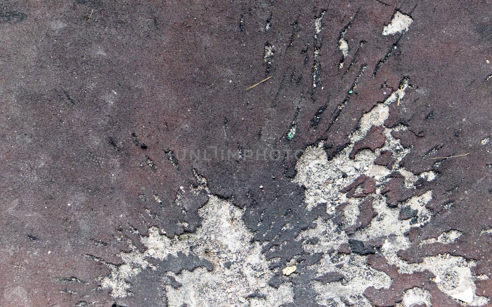 War in Ukraine. Funnel from the explosion in the asphalt. The trace left by the explosion of an artillery shell. Consequences of the rocket attack