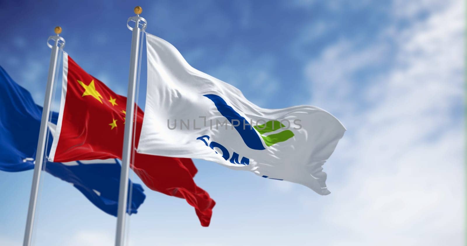 Shanghai, CH, May 2023: Flags of Comac and China waving in the wind. Comac is a Chinese state-owned aerospace manufacturer. Illustrative editorial 3d illustration render