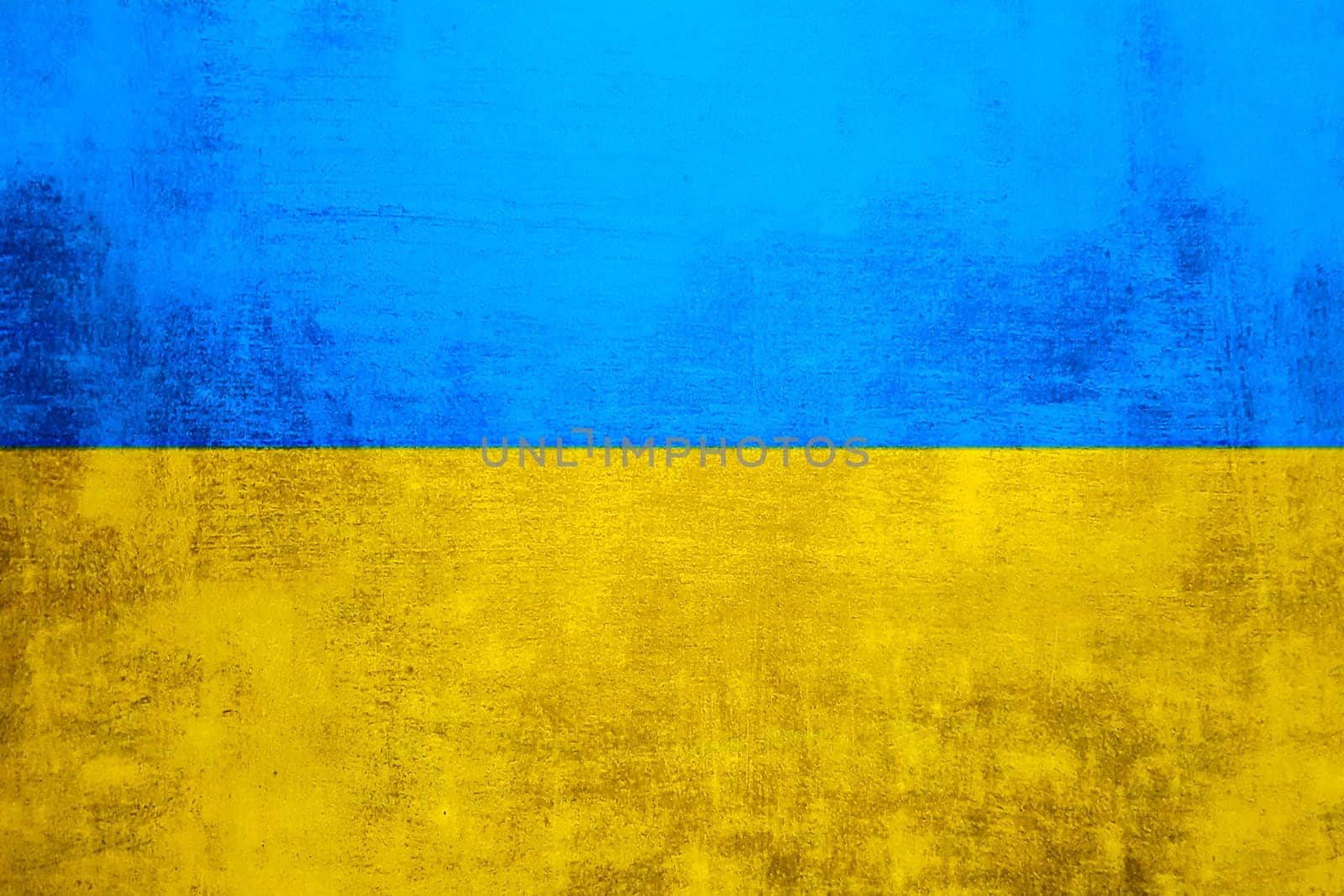 The wall is in the colors of the Ukrainian national flag - blue and yellow. Abstract texture background of concrete stone wall. Ukrainian flag on a grunge wall in connection with the war with Russia