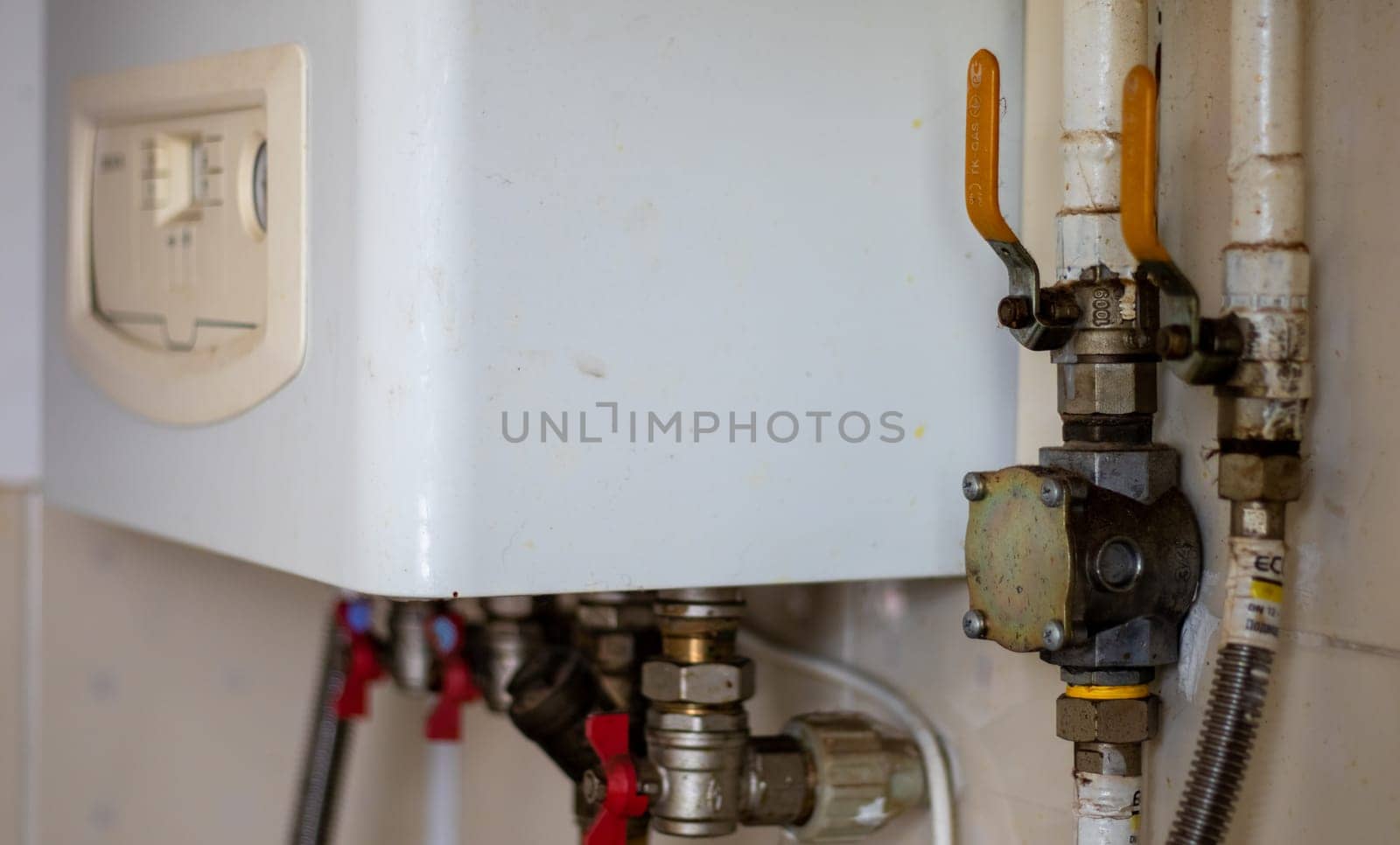 Heating gas boiler. Symbolic image of the heating season at home. The dial on a domestic combi boiler. Hot water and heating. Condensing boiler and boiler accessories