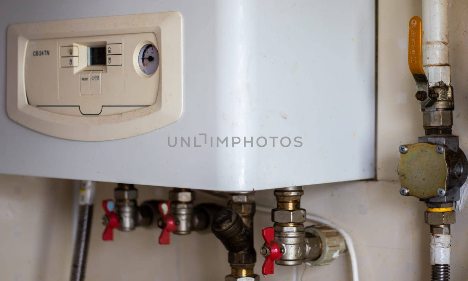 Heating gas boiler. Symbolic image of the heating season at home. The dial on a domestic combi boiler. Hot water and heating. Condensing boiler and boiler accessories