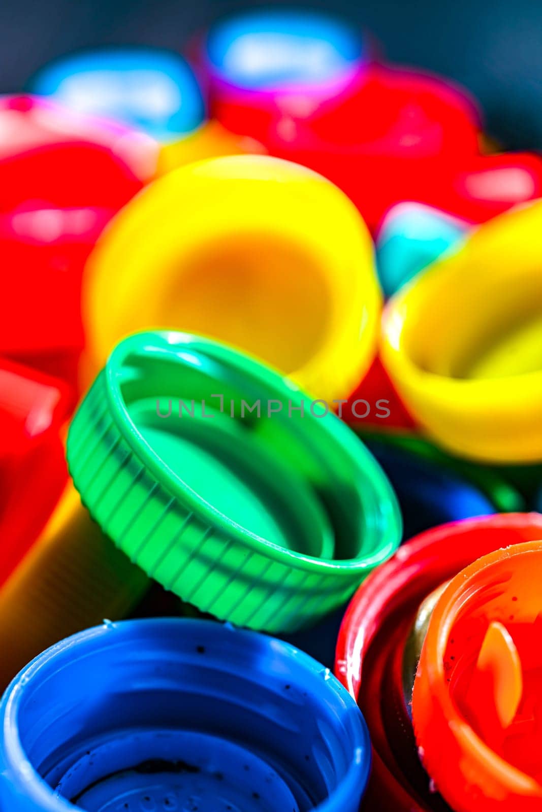 Different sorts of colorful plastic bottle caps. Recycling.