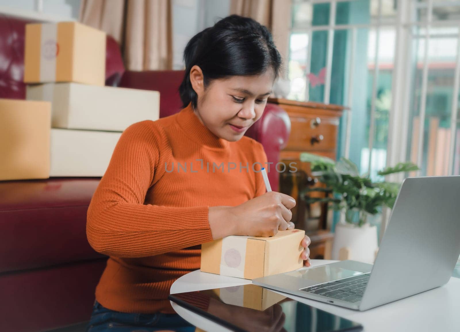 Asian woman receive order on laptop, Startup small business entrepreneur SME, Success young Asian small business owner home office, Online sell marketing delivery, Ecommerce concept, Online business.