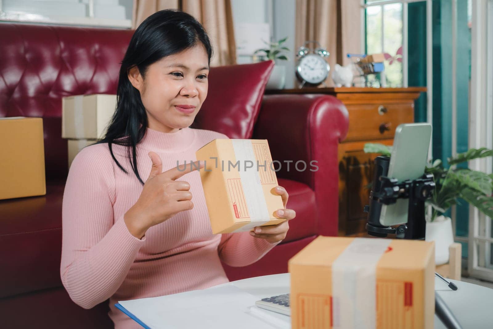 Asian blogger review products and video camera on her phone, sell them online, Business online influencer on social media concept, Ecommerce business live streaming vlog new normal concept.