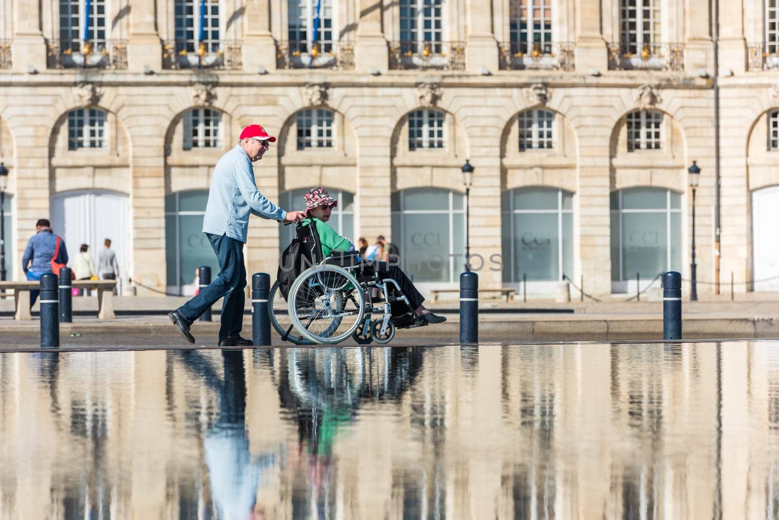 FRANCE, BORDEAUX - SEPTEMBER 20: People visiting a mirror fountain in front of Place de la Bourse in Bordeaux, France on September 20, 2015