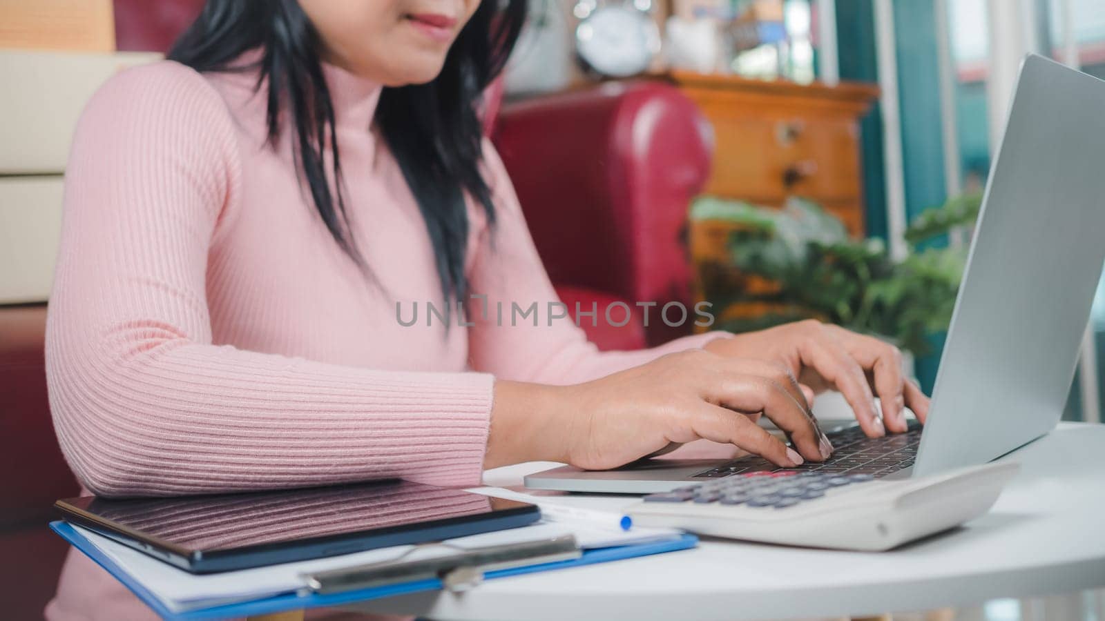 Businesswomen working business SME online at home her checking order from laptop for customer and online delivery for ready packing, Checking orders from customers with digital laptop, Small business.