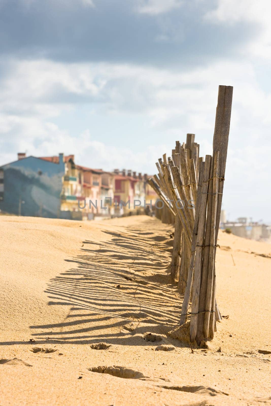 Wooden fence on an Atlantic beach in France, The Gironde Department. Shot with a selective focus