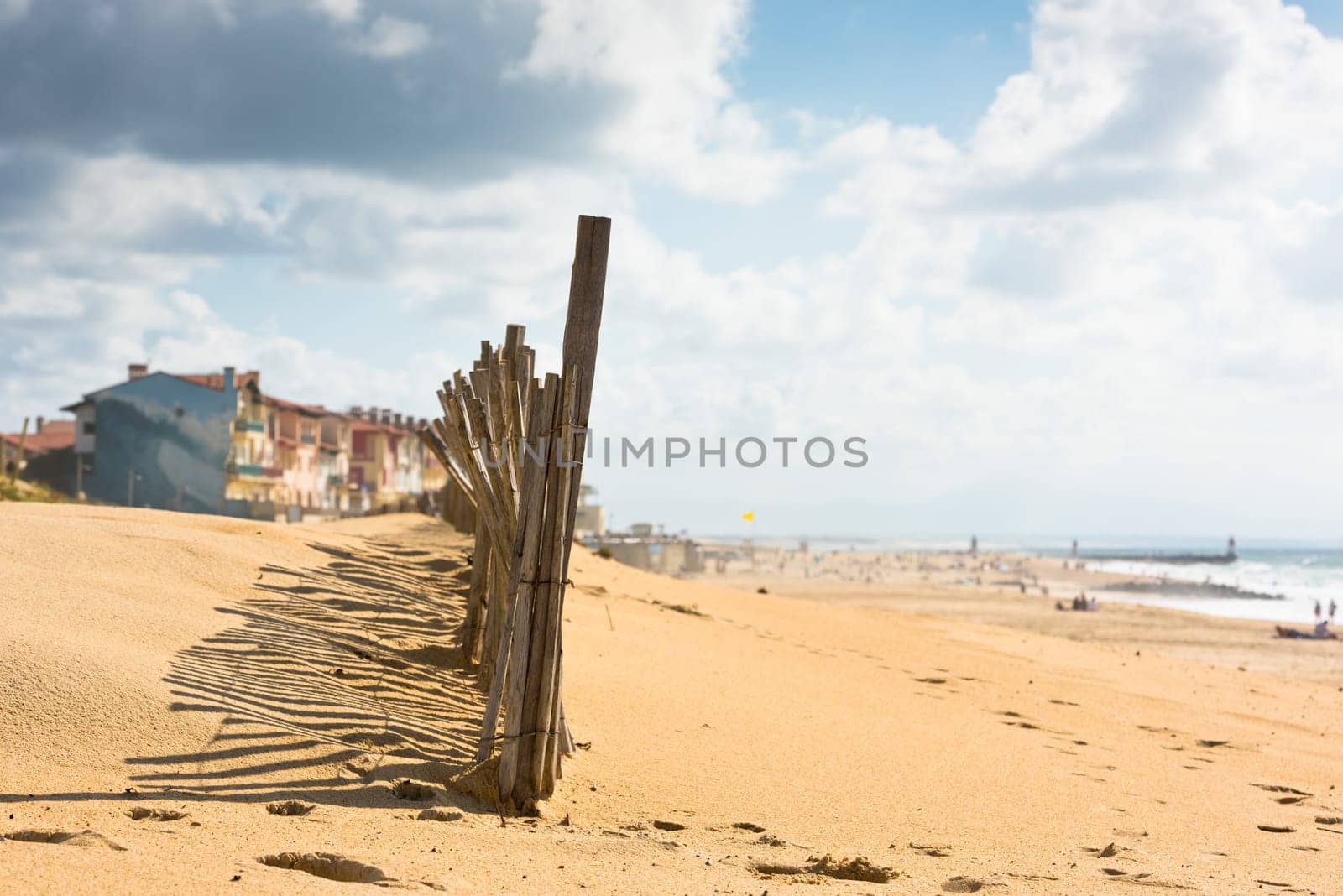 Wooden fence on an Atlantic beach in France, The Gironde Department. Shot with a selective focus