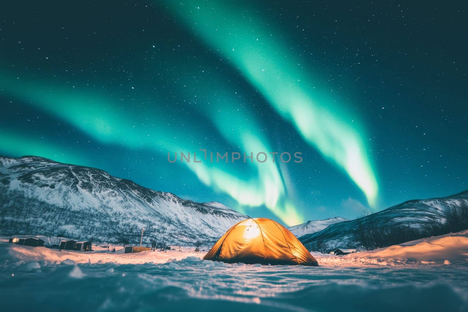 Illuminated tent under spectacular Northern Lights display with snowy mountains in background.