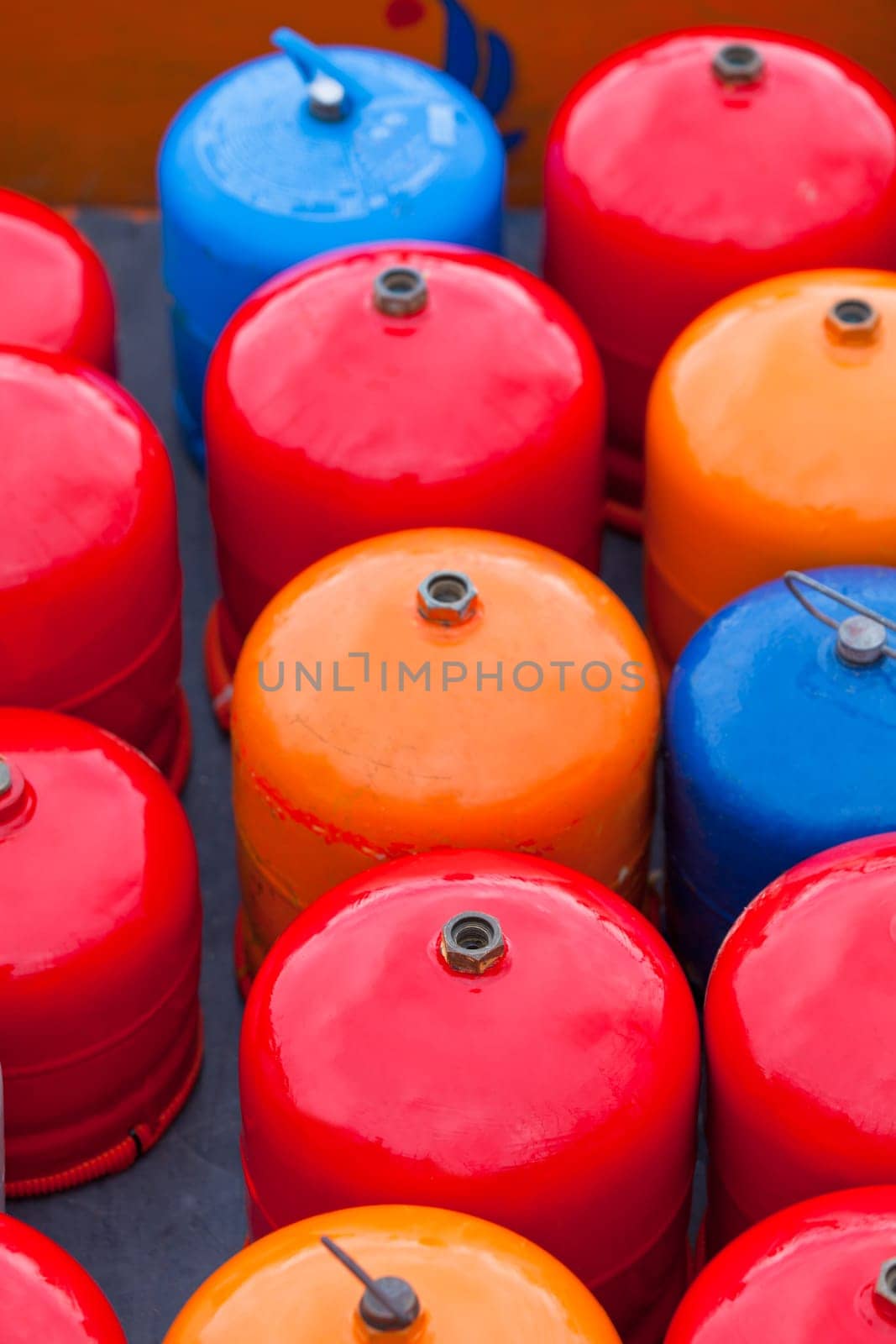 Bright metal gas bottles. Vertical outdoor shot