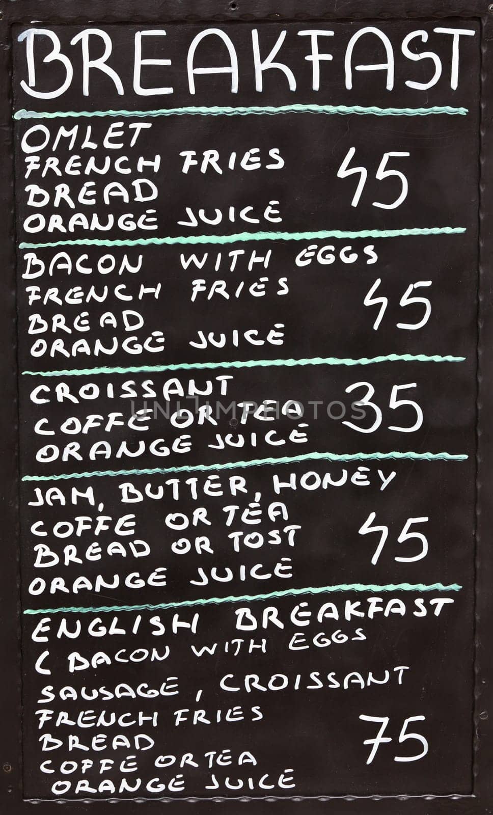 Street cafe breakfast menu written in chalk on a blackboard. Vertical shot