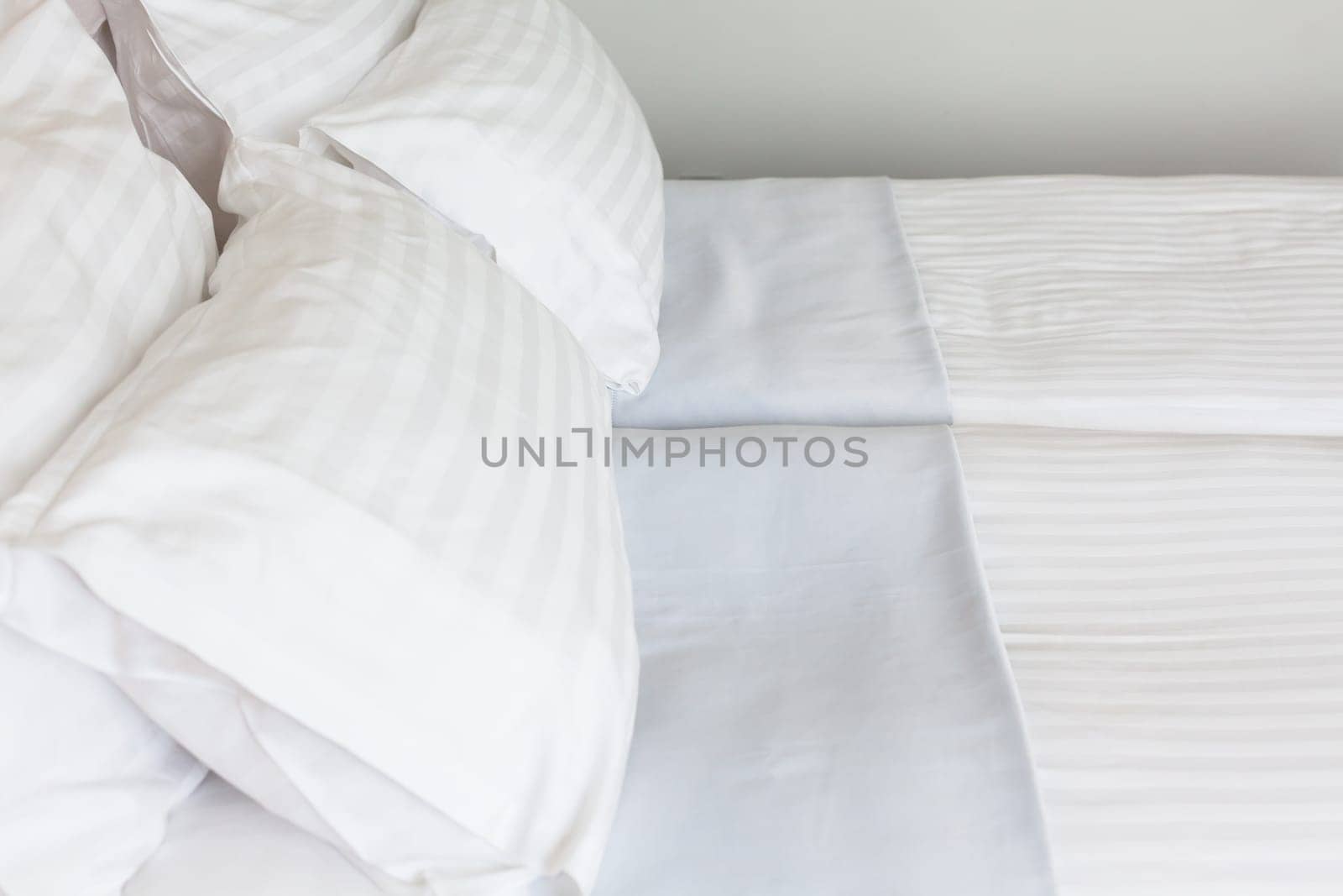 Prepared fresh bed, scene in hotel room. Horizontal shot