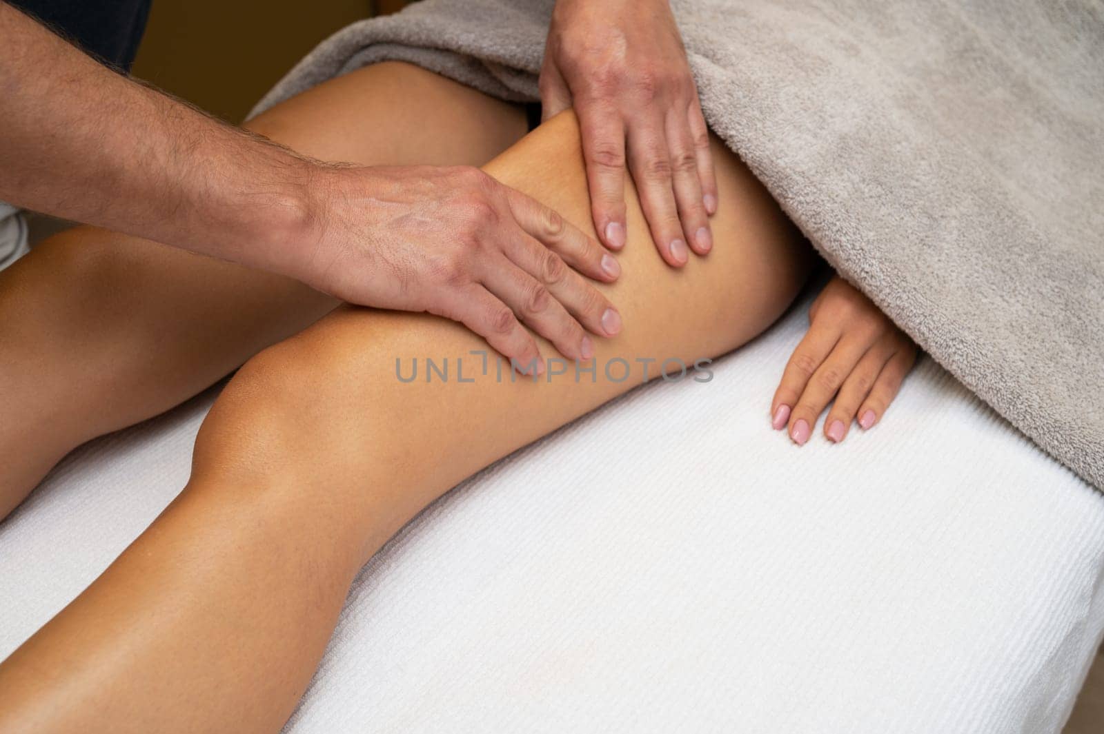 Woman getting legs lymphatic drainage massage in spa salon. Closeup. Body relaxation beauty and body care concept.