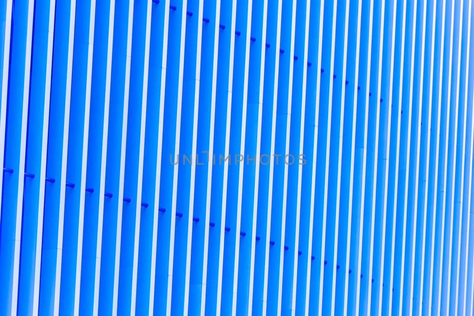 Detail of pattern striped metal facade for blue background