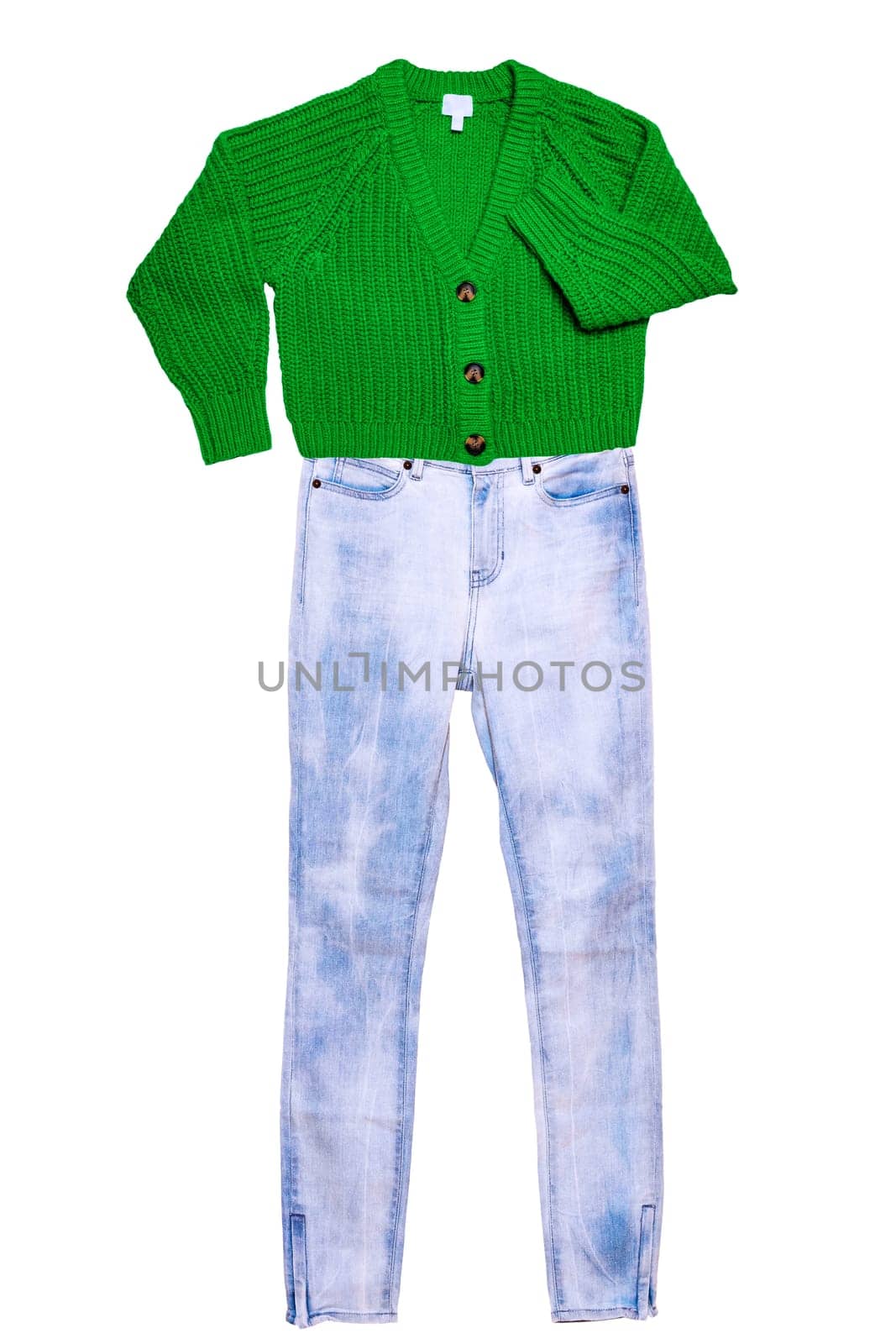 Womans denim jeans with a casual elegant fluffy cardigan with V-neck and button closure isolated on a white background. Autumn and winter fashion.