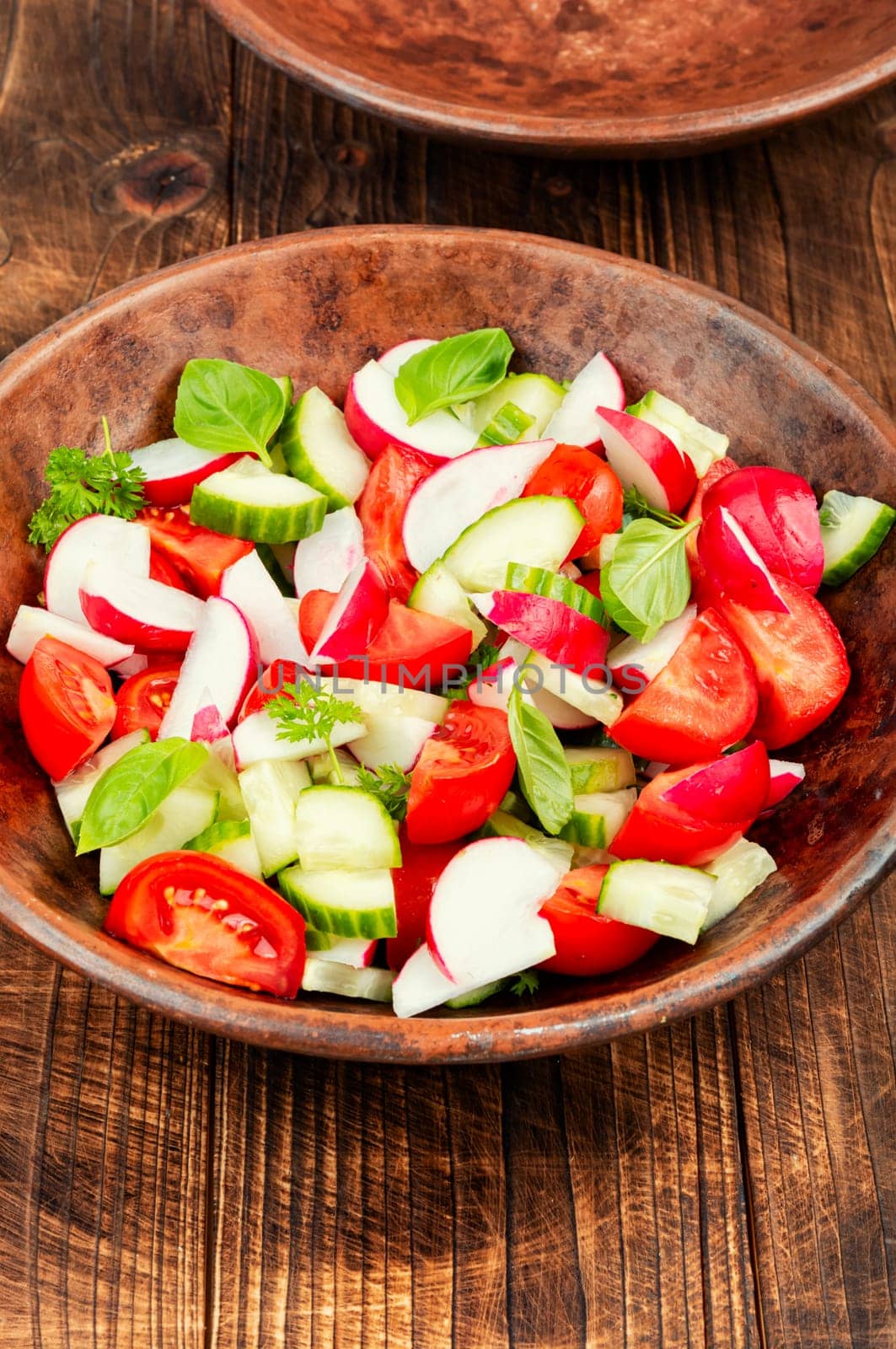 Vegetarian salad of radishes, cucumber and tomatoes. Diet menu.