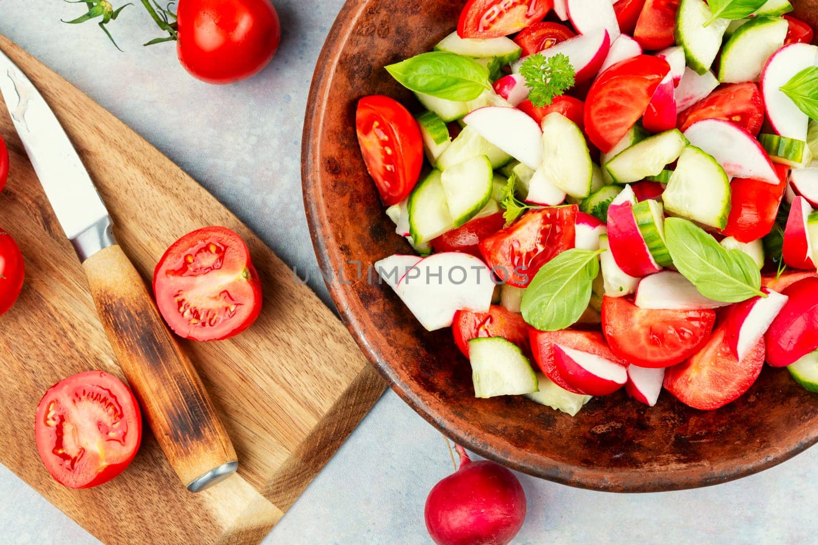 Vegetarian salad of radishes, cucumber and tomatoes. Diet menu.