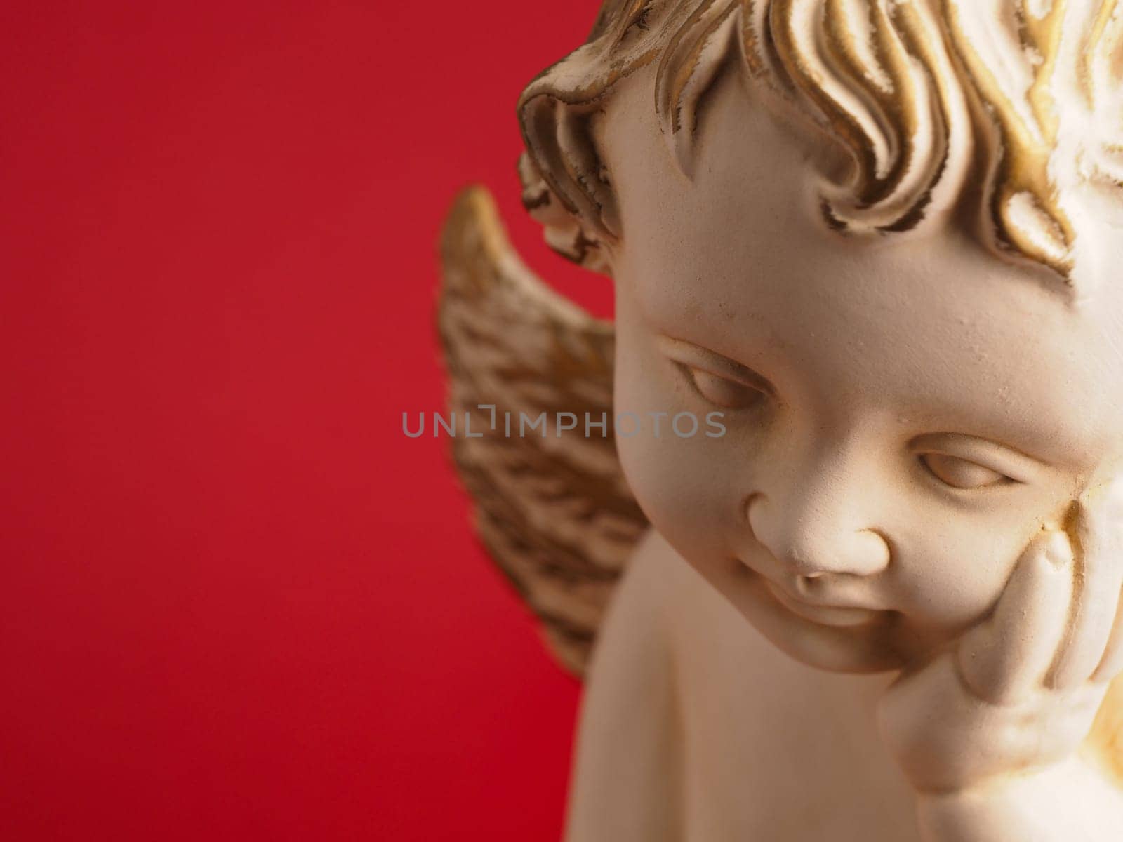Close-up of a Christmas angel against a red background, Christmas or holiday background