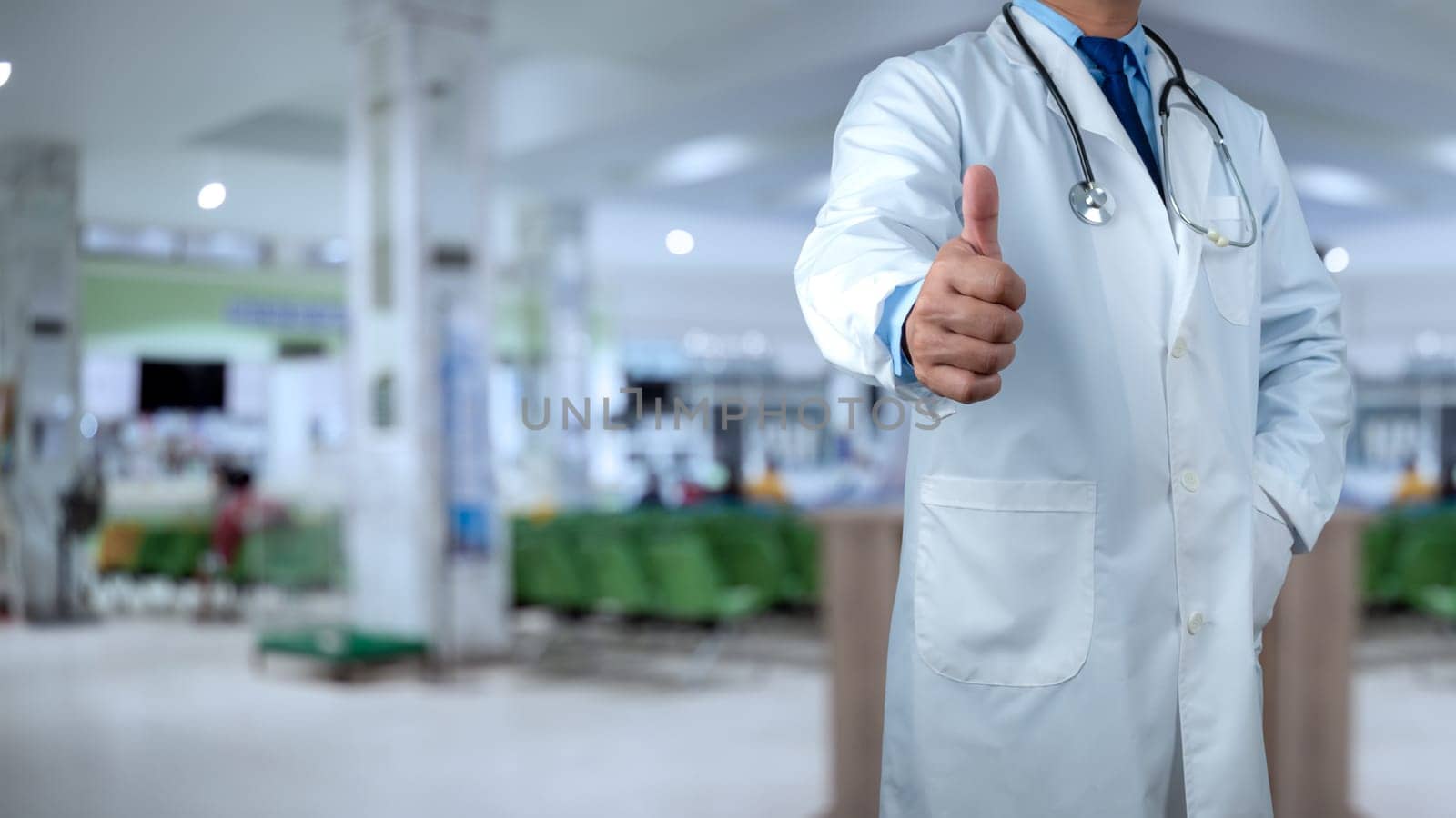 Doctors standing with thumbs up or Ok sign in hospital office, close-up. Physicians ready to examine and help patients, Medical help, Best treatment, Insurance in health care and medicine concept.