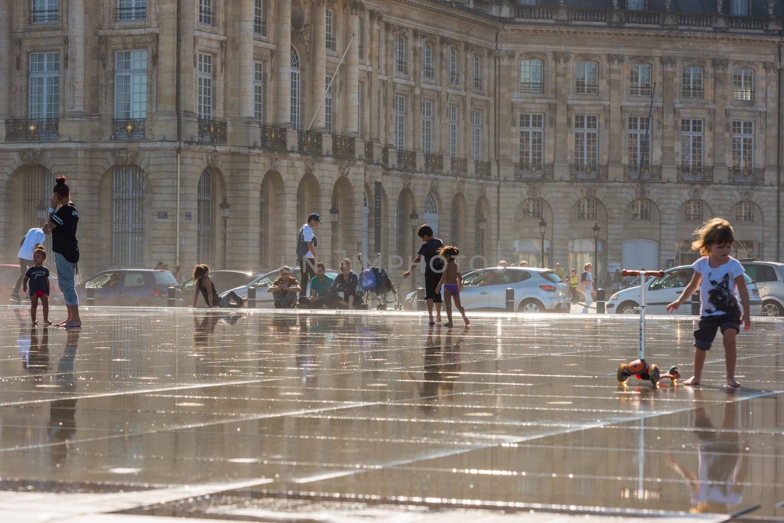 FRANCE, BORDEAUX - SEPTEMBER 20: People having fun in a mirror fountain in front of Place de la Bourse in Bordeaux, France on September 20, 2015