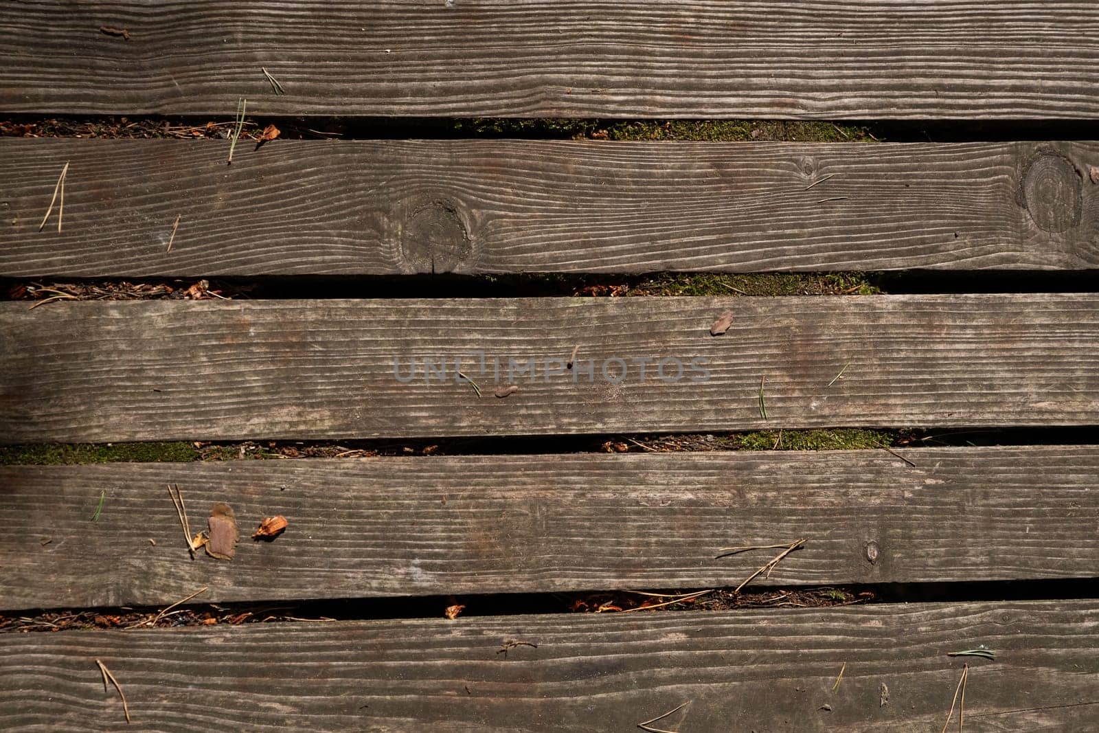 Close up of old abandoned rickety foot bridge. Old wood texture background coming from natural tree. The wooden panel has a beautiful dark pattern.