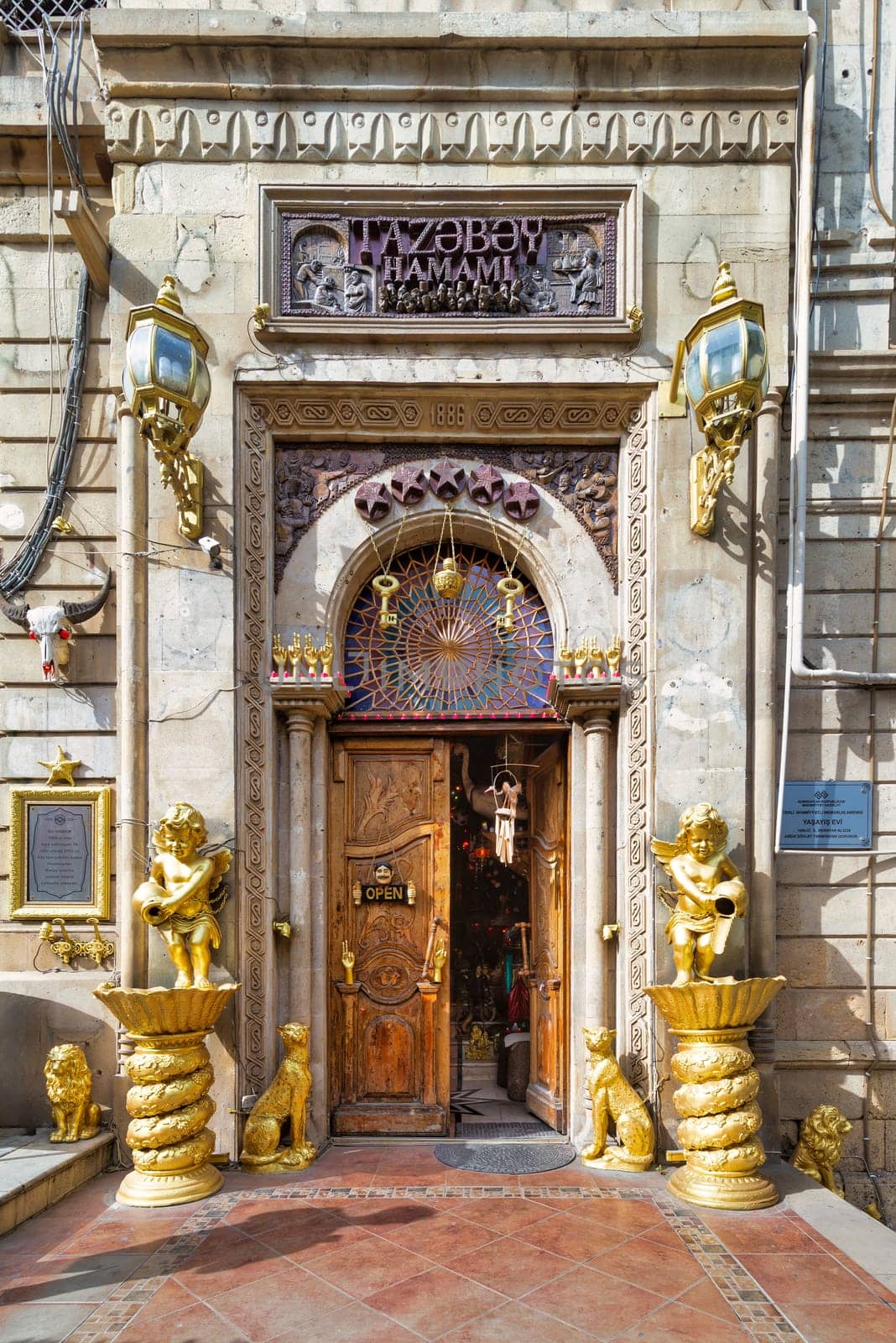 Ornate entrance of Tazabay Hamami, Bathhouse, adorned with golden sculptures and intricate designs, inviting relaxation in Baku, Azerbaijan