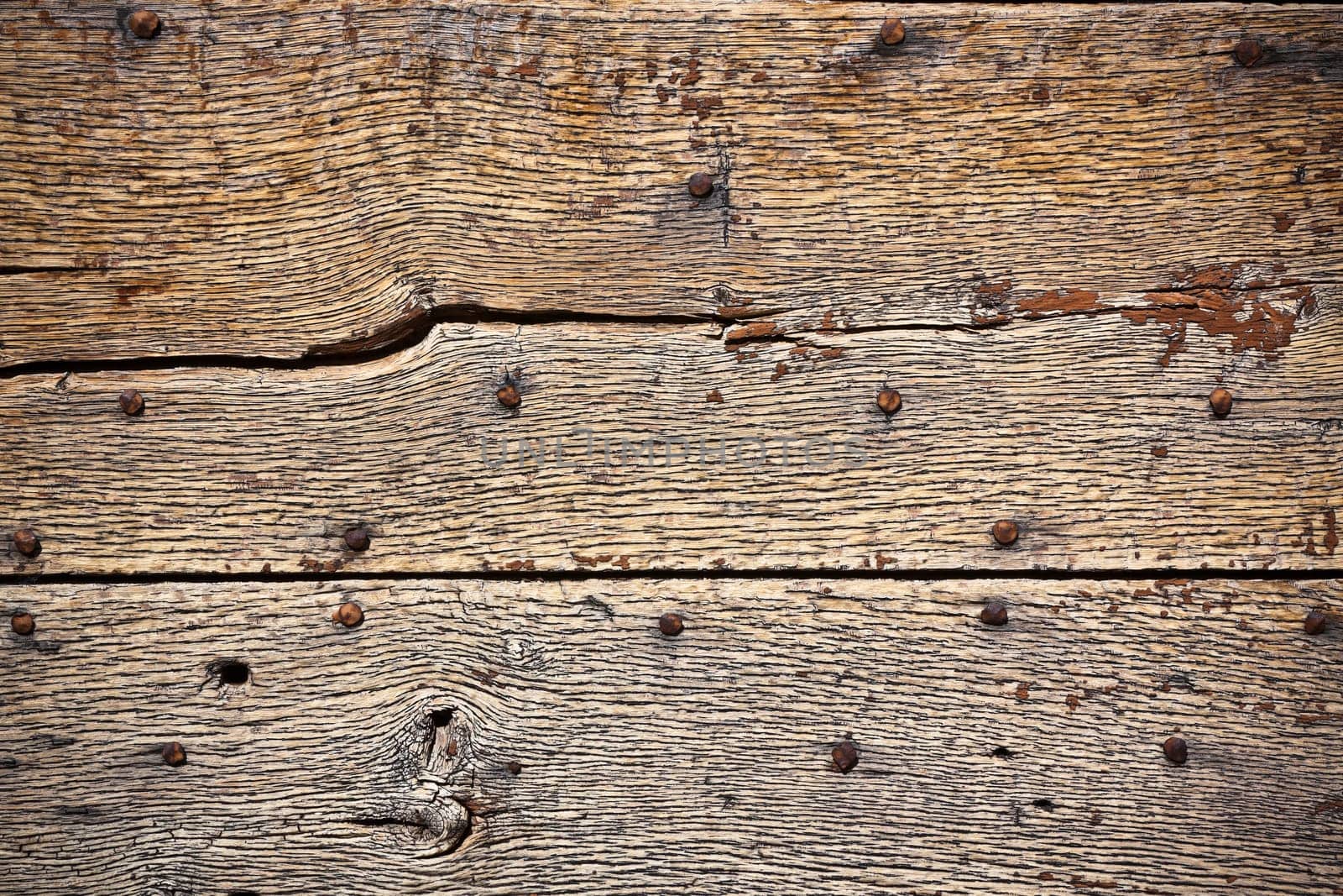 Wooden surface with old metal rivets background. Horizontal shot