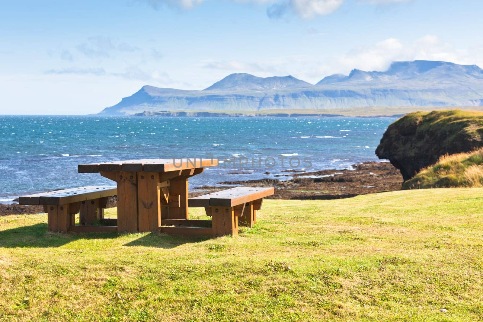 Empty Wooden table and benches in resting area at roadside