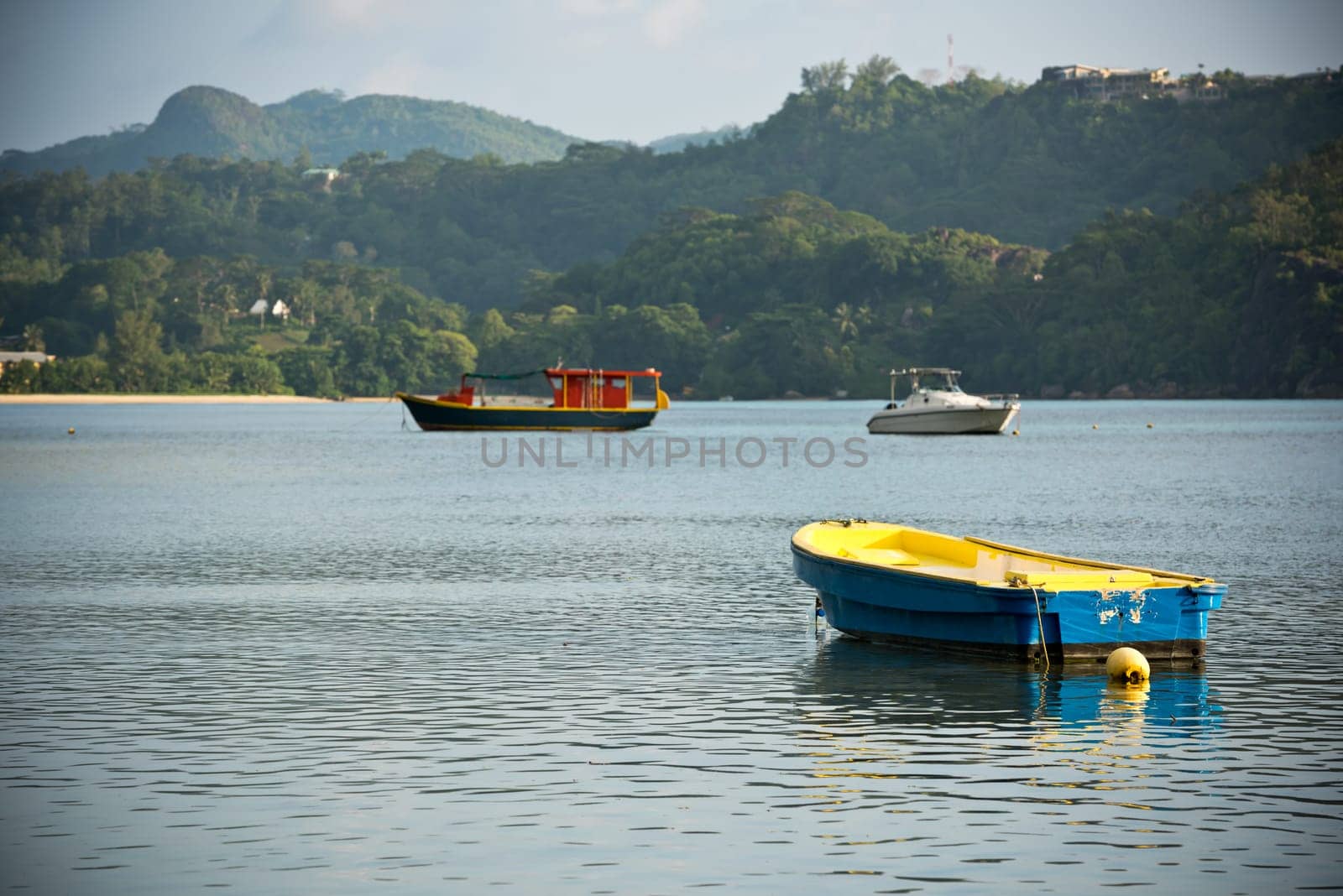 View of Seychelles coastline with a boats on a foreground. Horizontal shot