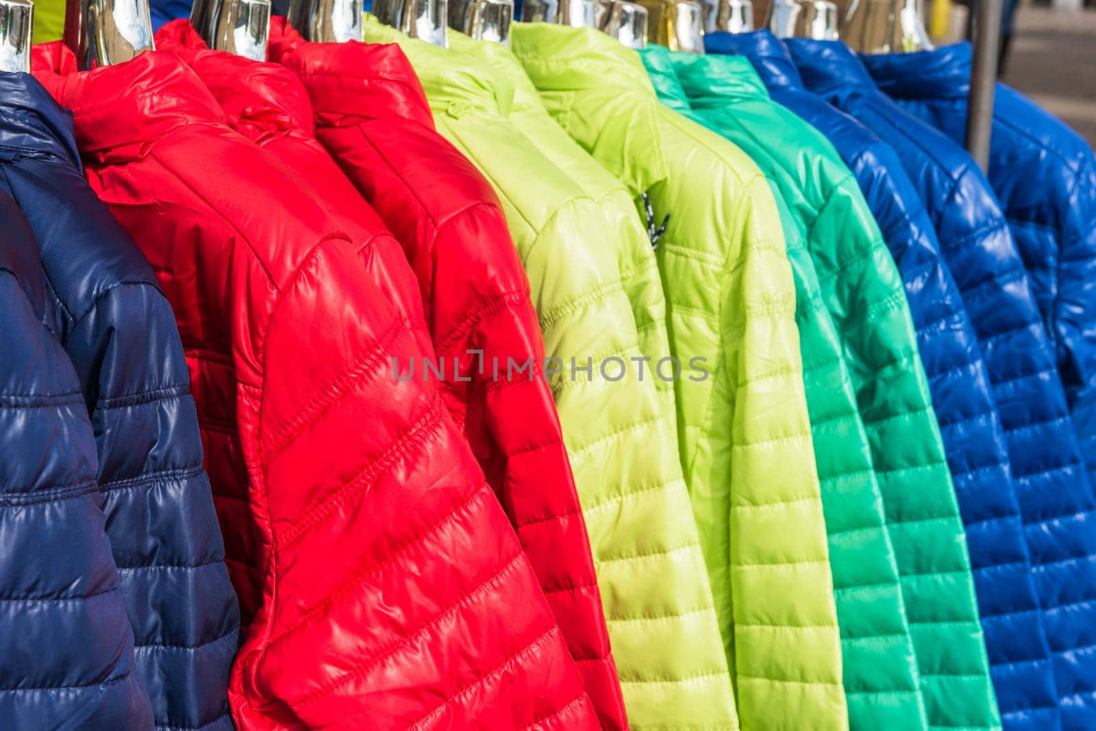 Bright winter clothes hanging at a fashion store