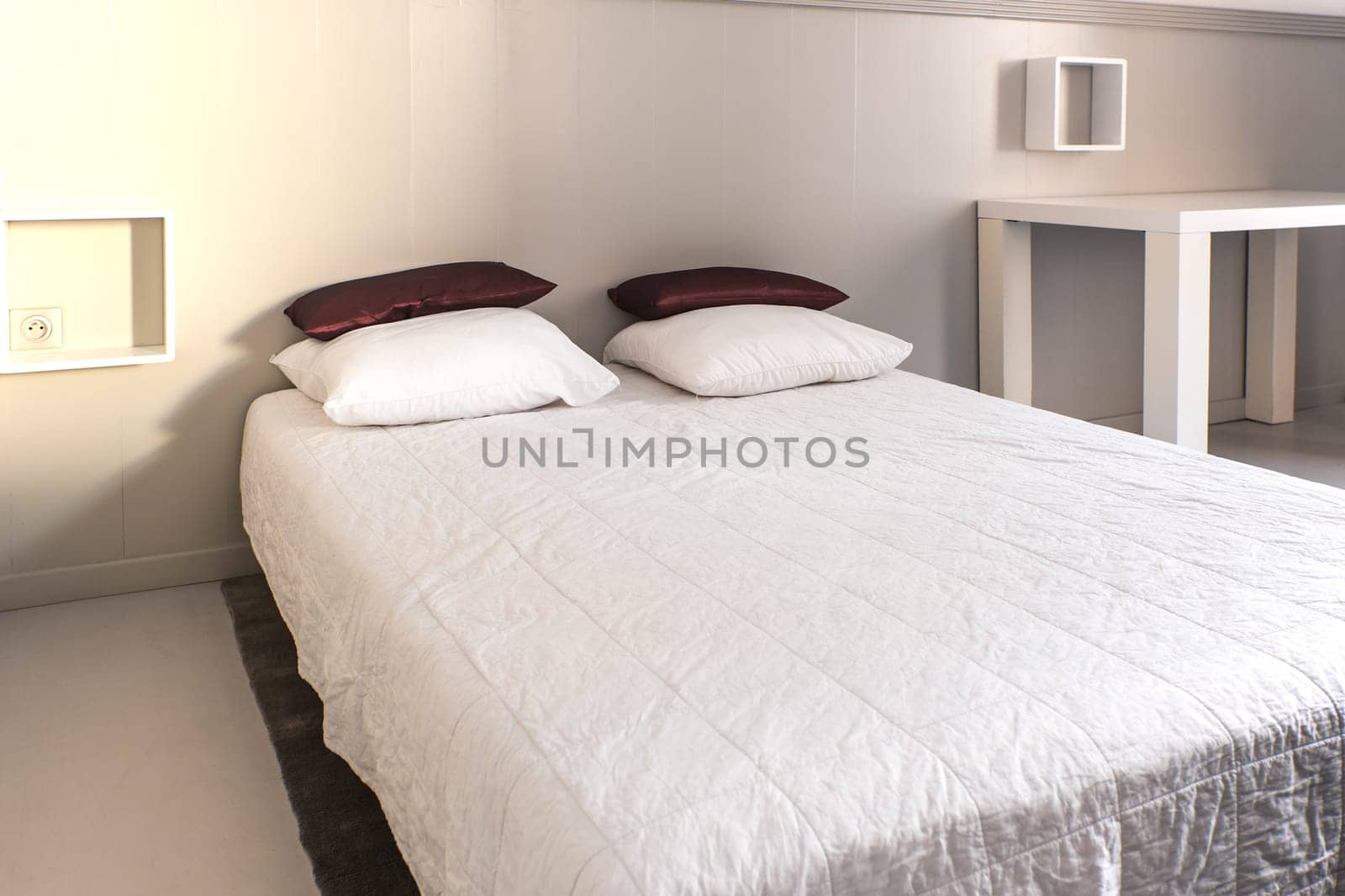 Prepared fresh bed, scene in apartments room. Horizontal shot