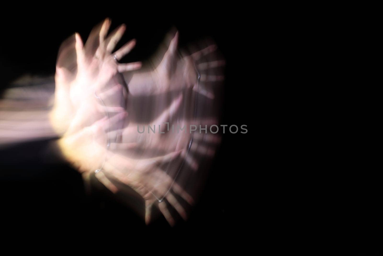 Long exposure of a woman's hand at night