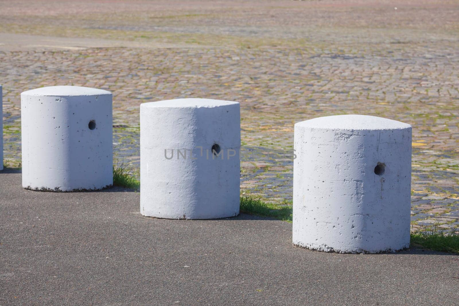 Concrete bollards on a road, Germany