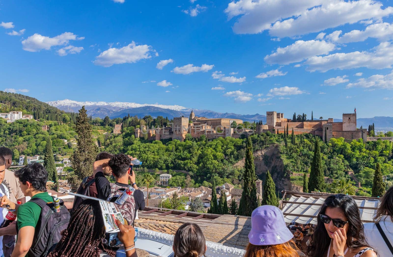 Granada, Spain: April 15, 2024: People at the Alhambra palace with the Sierra Nevada in the background, Granada, Andalusia, Spain