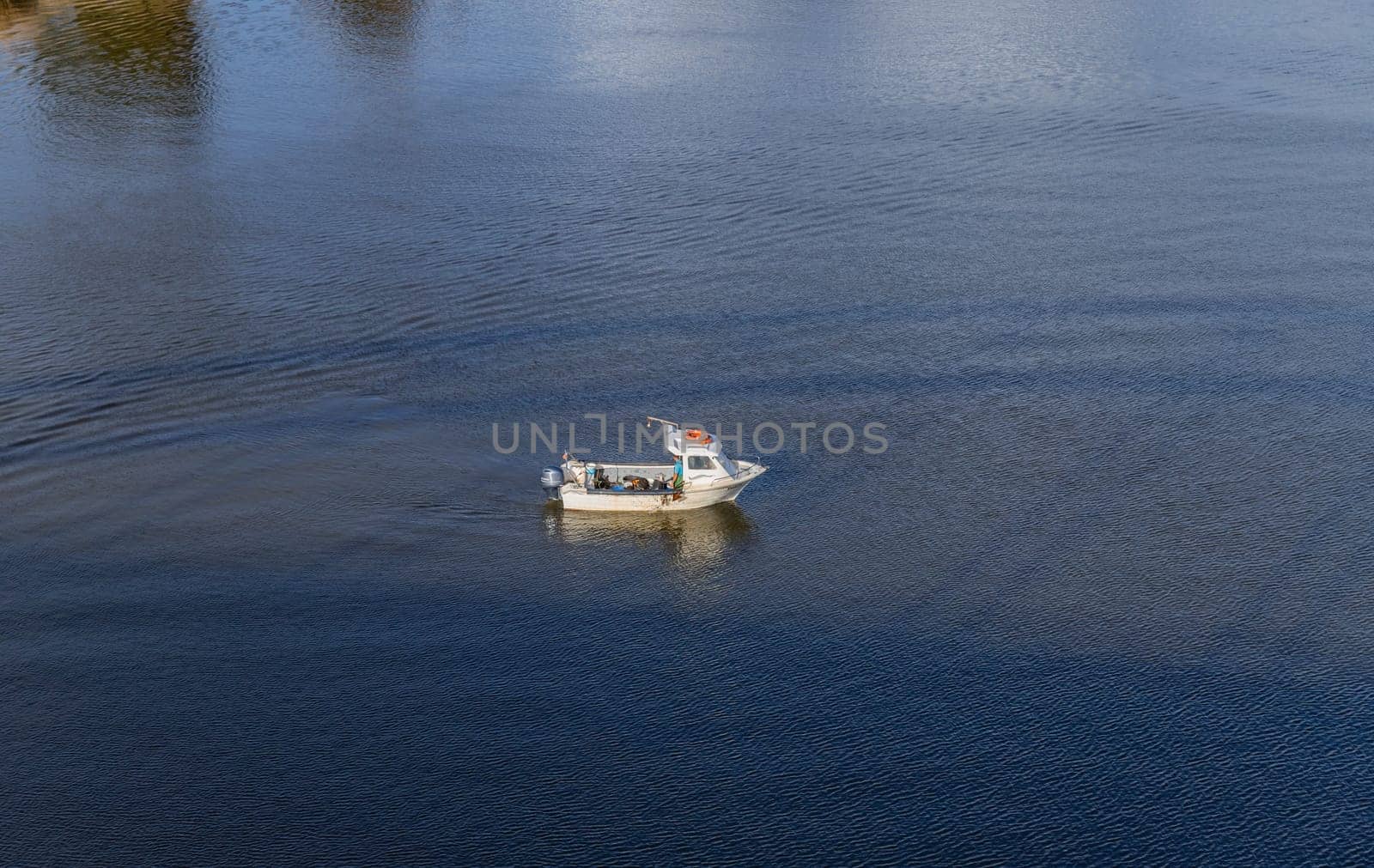 Lisbon, Portugal: February 16, 2024: Fisherman fishing in tagus river near Lisbon, Portugal
