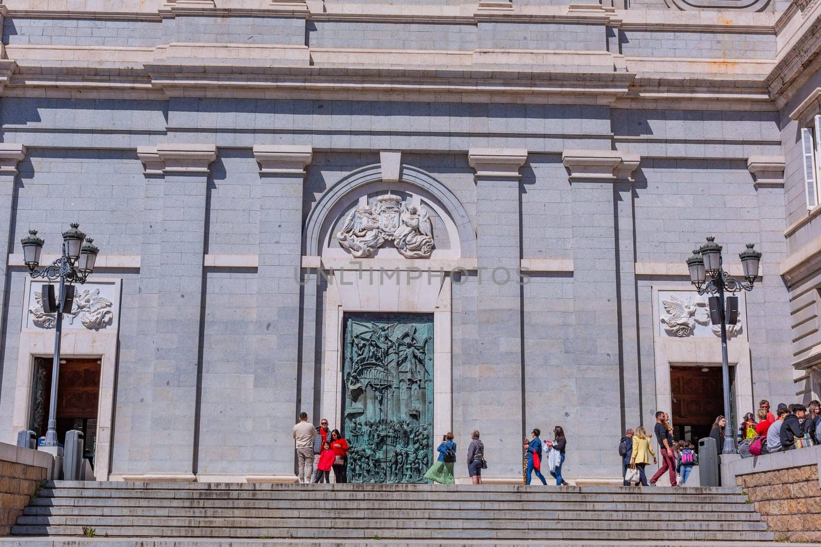 Madrid, Spain: April 24, 2024: People at the entrance of the Almudena Cathedral, Santa Maria la Real de La Almudena.