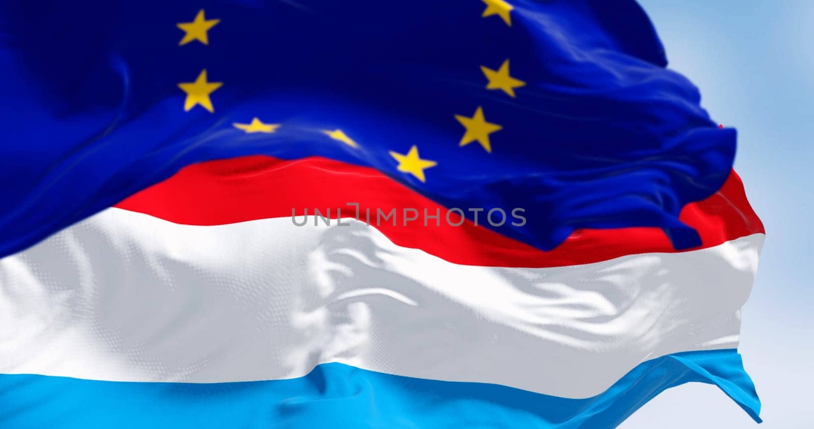 Close-up of of Luxembourg and the European Union flags waving in the wind on a clear day. 3d illustration render. Fluttering textile. Selective focus