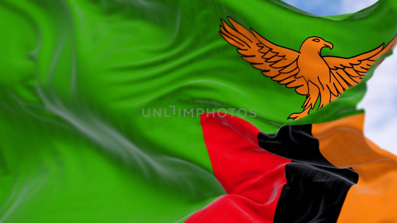 Close-up of Zambia national flag waving in the wind. Green with an orange eagle in flight over a block of three vertical stripes in red, black, and orange. 3d illustration render. Selective focus