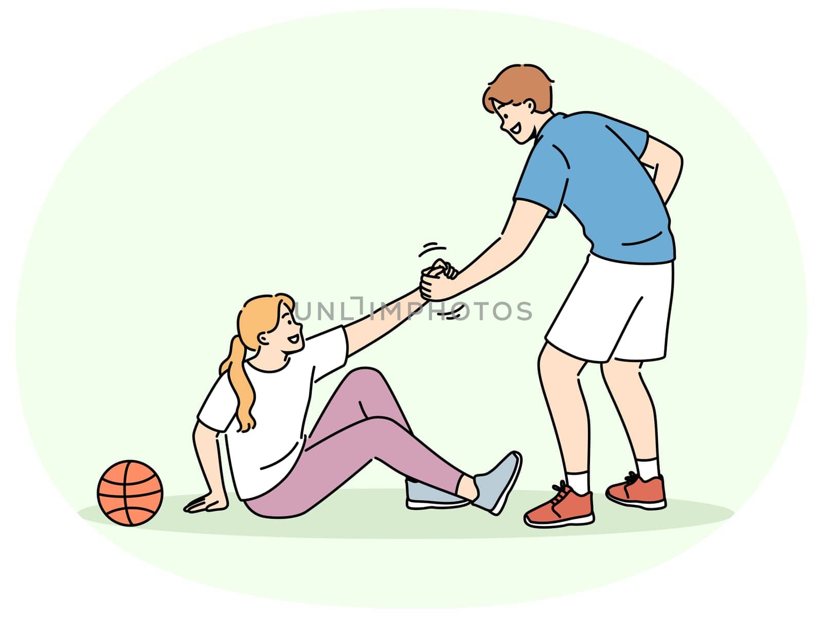 Basketball caviar helps fallen girl to stand up, showing team solidarity with injured opponent. Responsive friend lending helping hand to friend sitting on ground near basketball ball