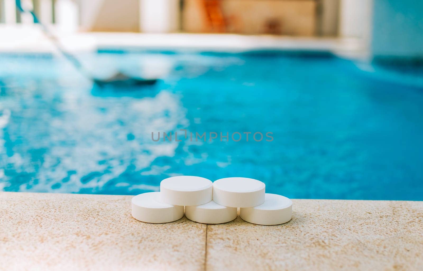 Chlorine tablets for swimming pool cleaning. close up of chlorine tablets on the edge of a swimming pool